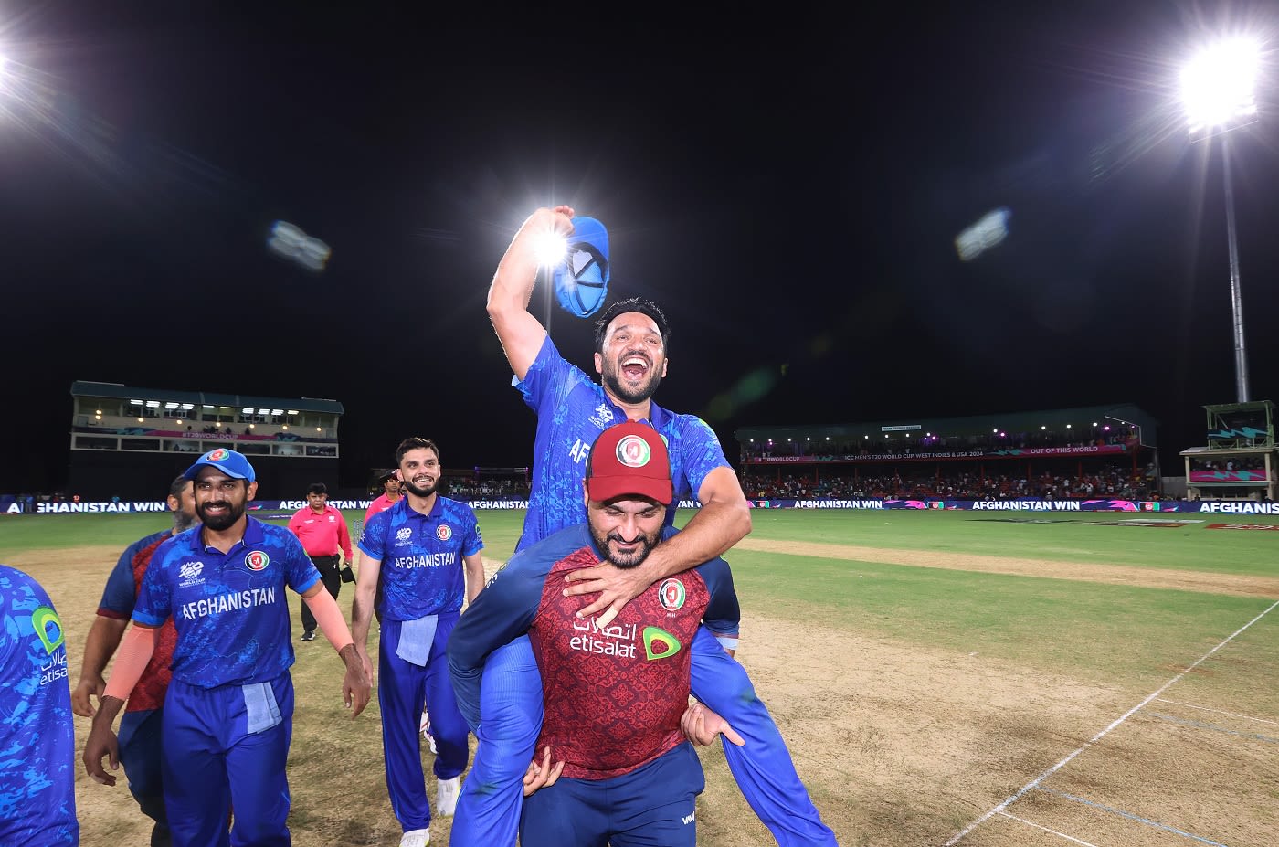 Gulbadin Naib is carried on his shoulders by Afghanistan's bowling coach Hamid Hassan