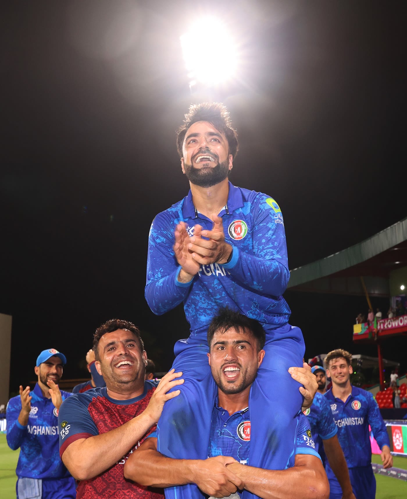 Rashid Khan is carried aloft after the victory by Nangyal Kharote