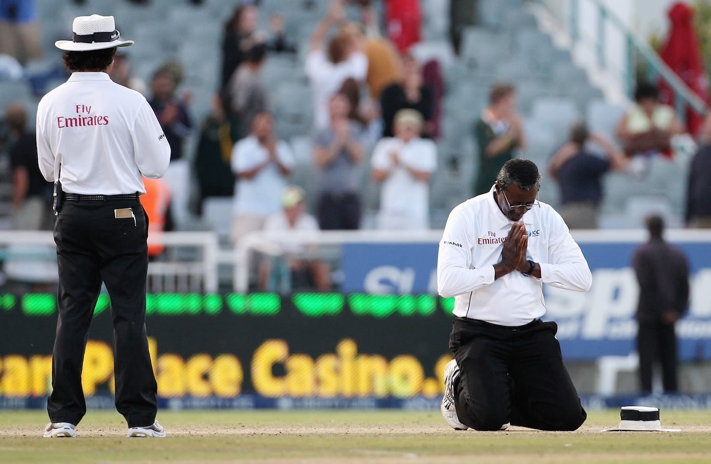 Steve Bucknor prays on the pitch during his final Test