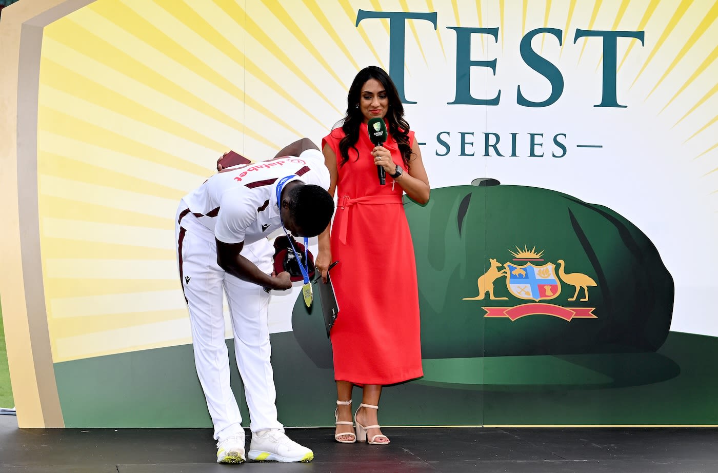 The player of the match and series, Shamar Joseph, takes a bow