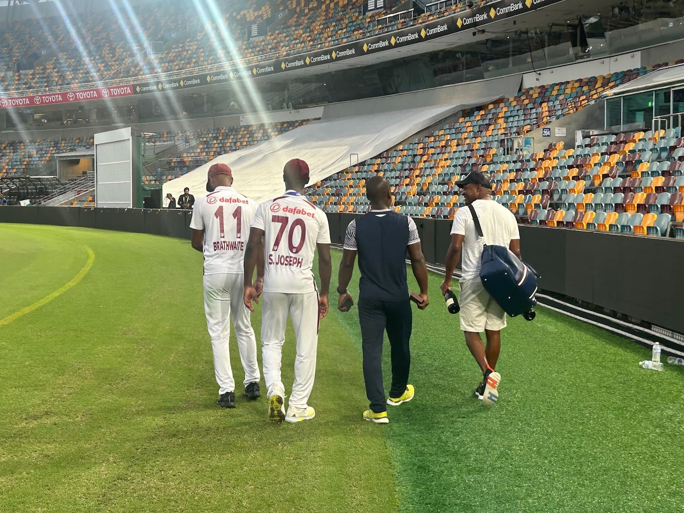 Kraigg Brathwaite, Shamar Joseph and Brian Lara walk alongside each other