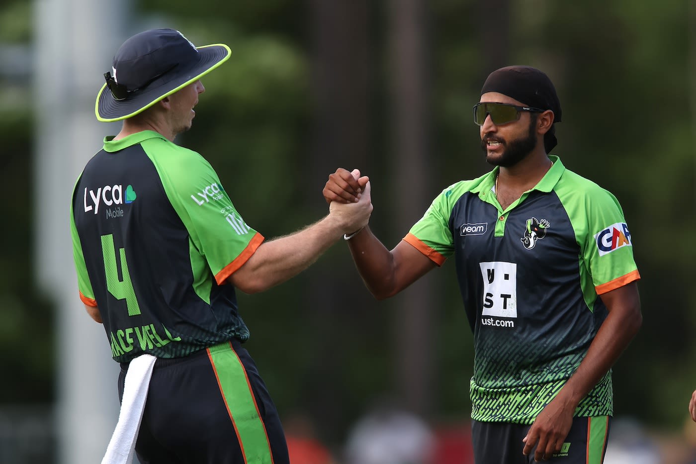 Michael Bracewell congratulates Harmeet Singh after a wicket