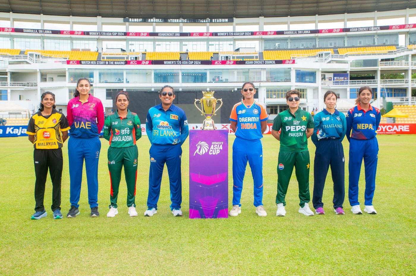 The eight captains strike a pose with the trophy ahead of the 2024 Women's Asia Cup