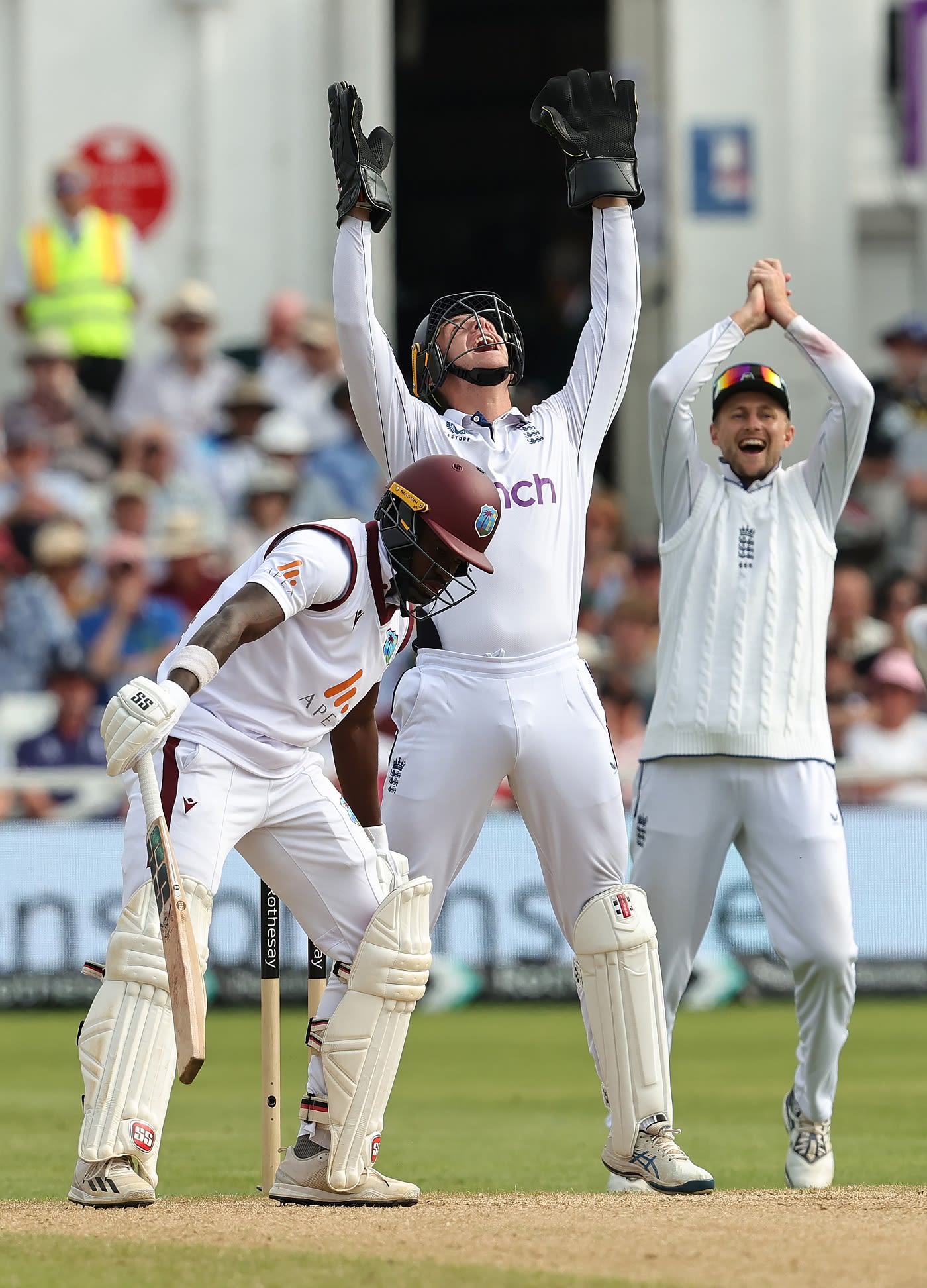Jamie Smith and Joe Root go up in unison to celebrate Kirk McKenzie's dismissal