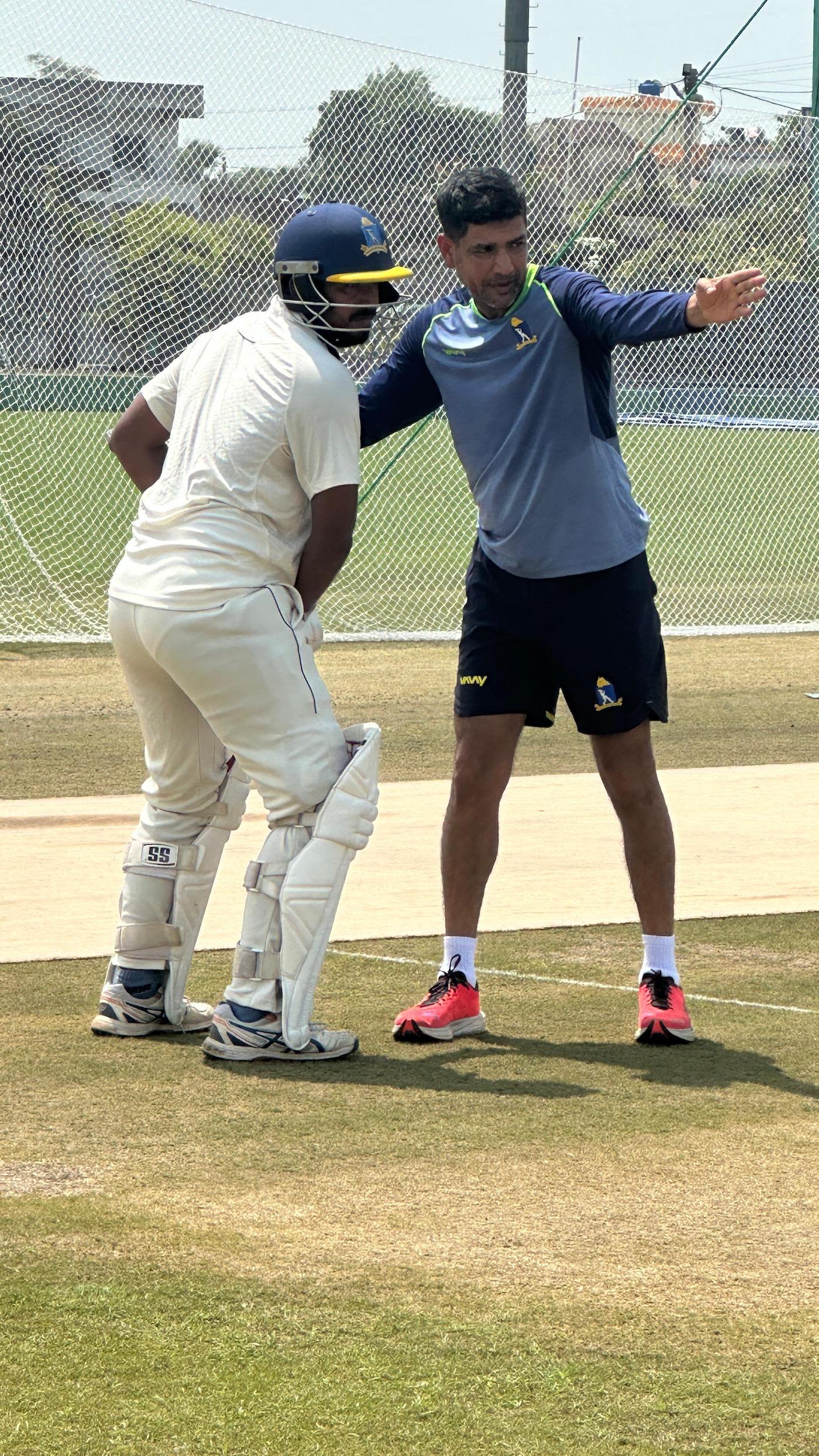 Laxmi Ratan Shukla helps out Shreyansh Ghosh in the nets