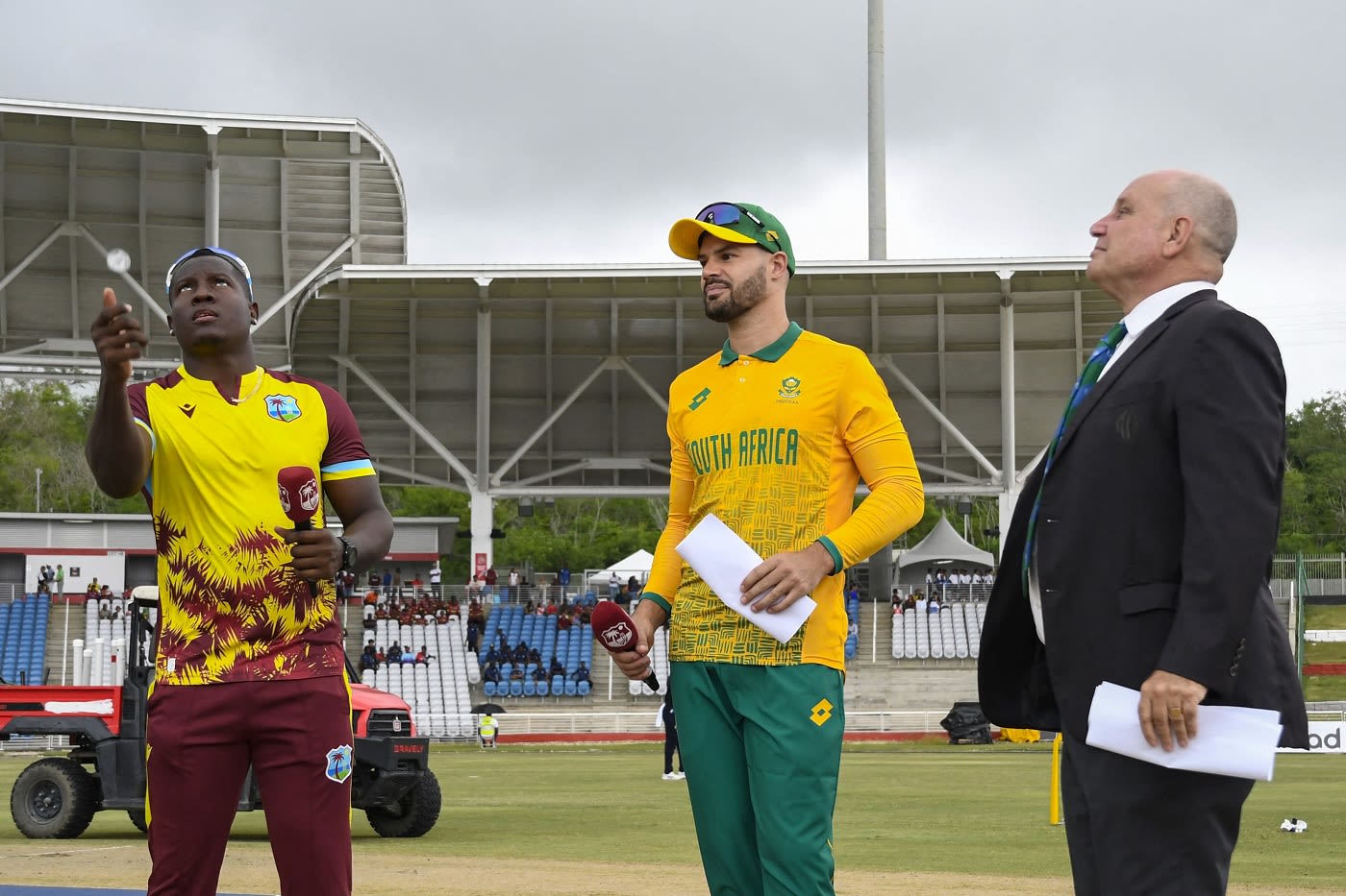 Rovman Powell, Aiden Markram and match referee Andy Pycroft at the toss