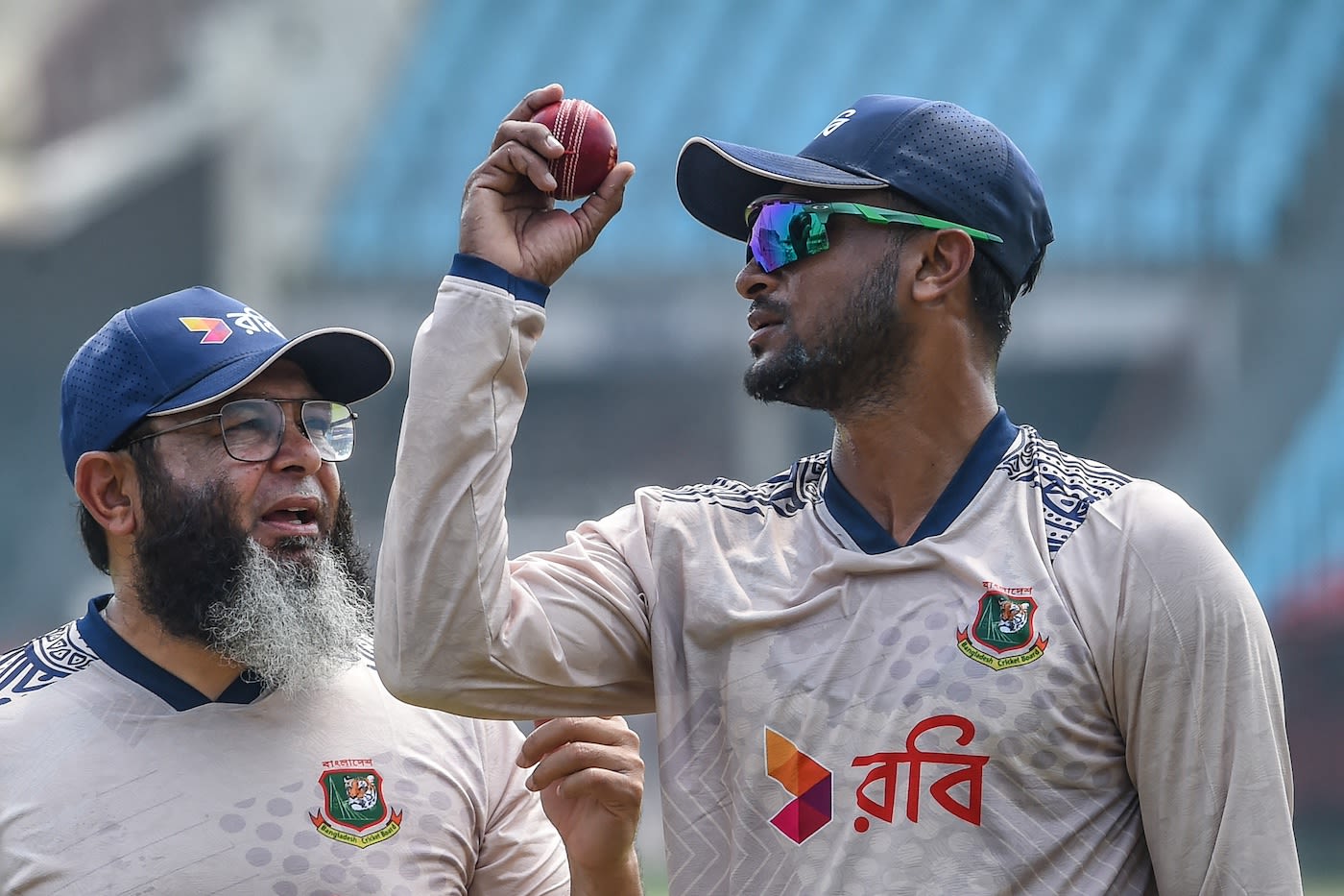 Shakib Al Hasan talks with bowling coach Mushtaq Ahmed
