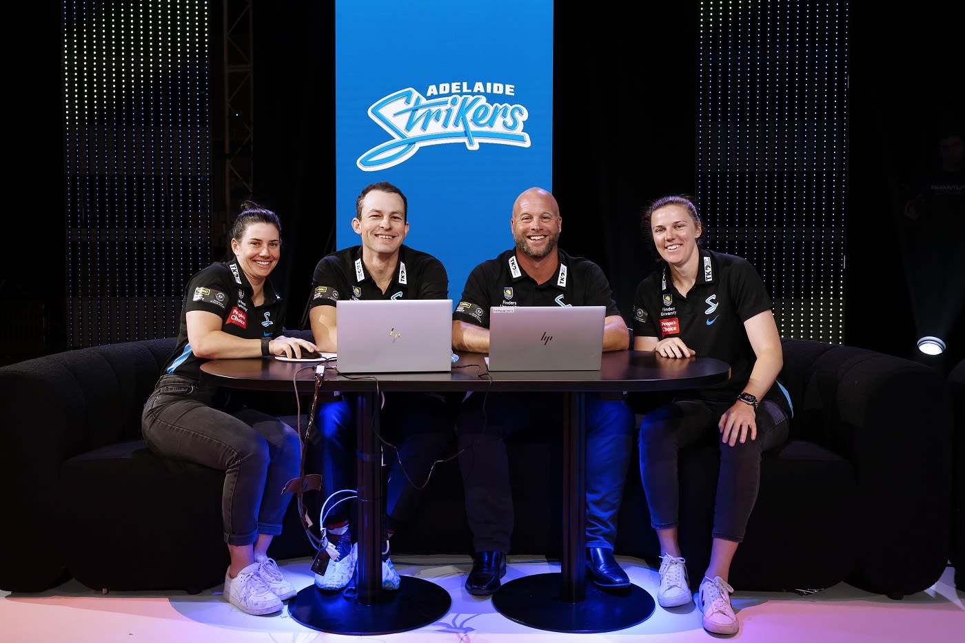 Nicole Bolton, Jarrod Harkness, head coach Luke Williams and captain Tahlia McGrath are all smiles at the Strikers table
