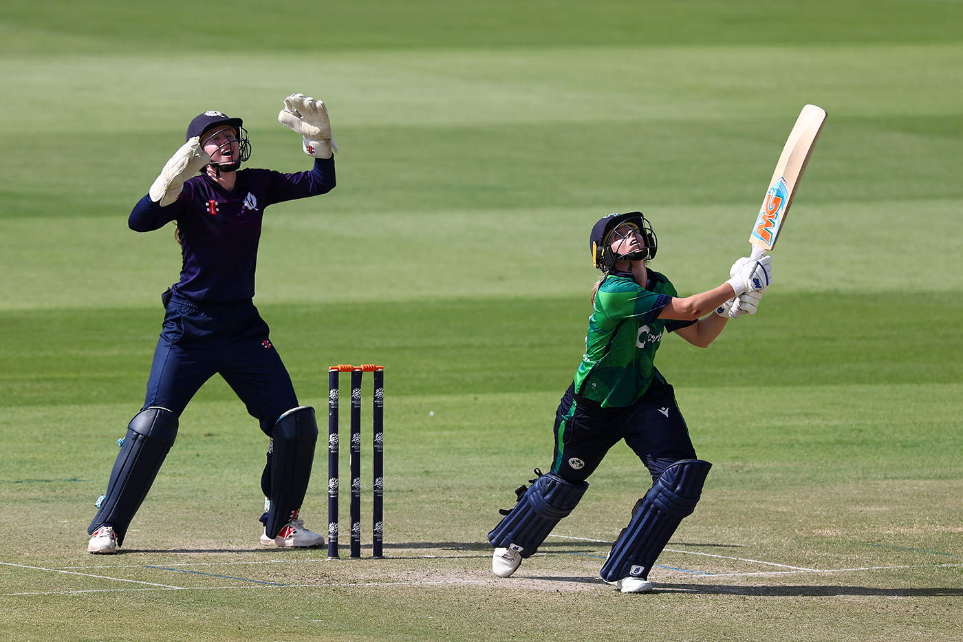 Wicketkeeper Sarah Bryce watches Eimear Richardson hit one in the air