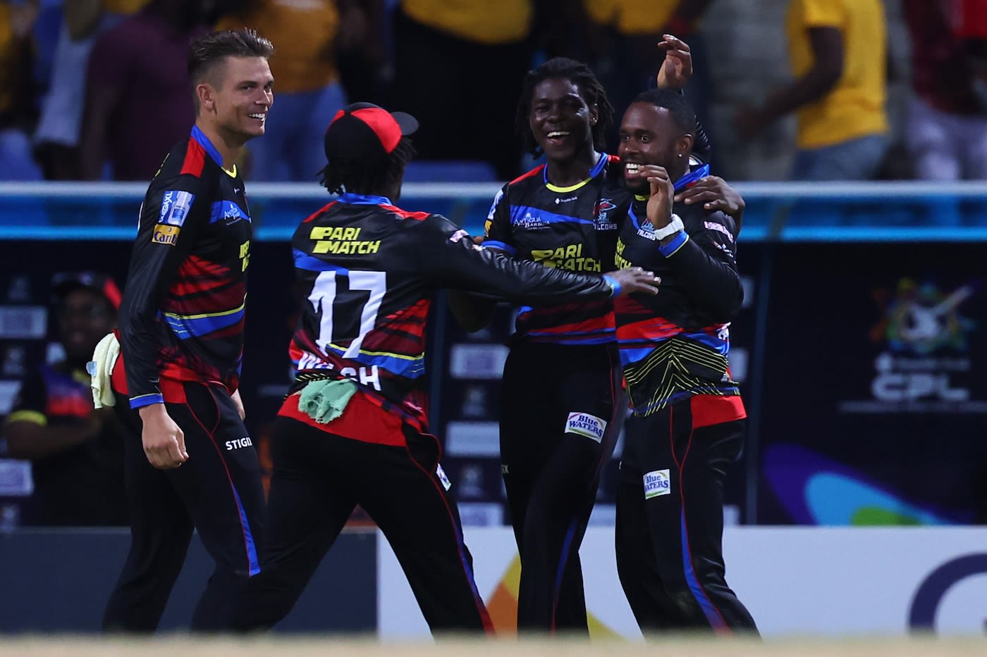 Team-mates get around Fabian Allen after one of his wickets