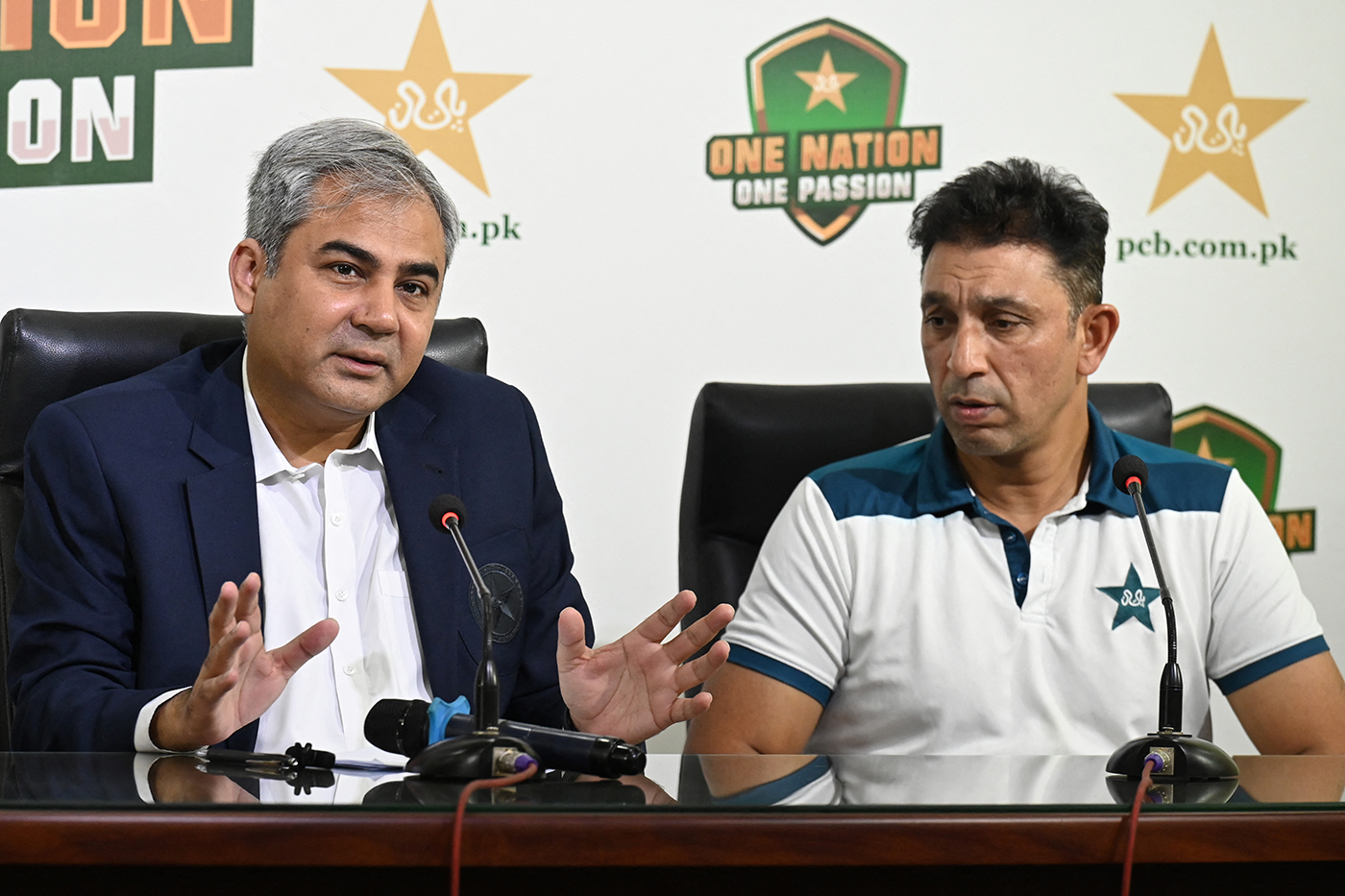 Pakistan board chairman Mohsin Naqvi and assistant coach Azhar Mahmood talk to the press
