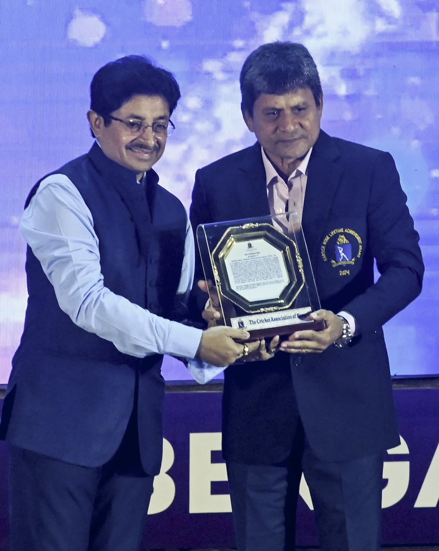 CAB president Snehasish Ganguly presents the lifetime achievement award to Pranab Roy