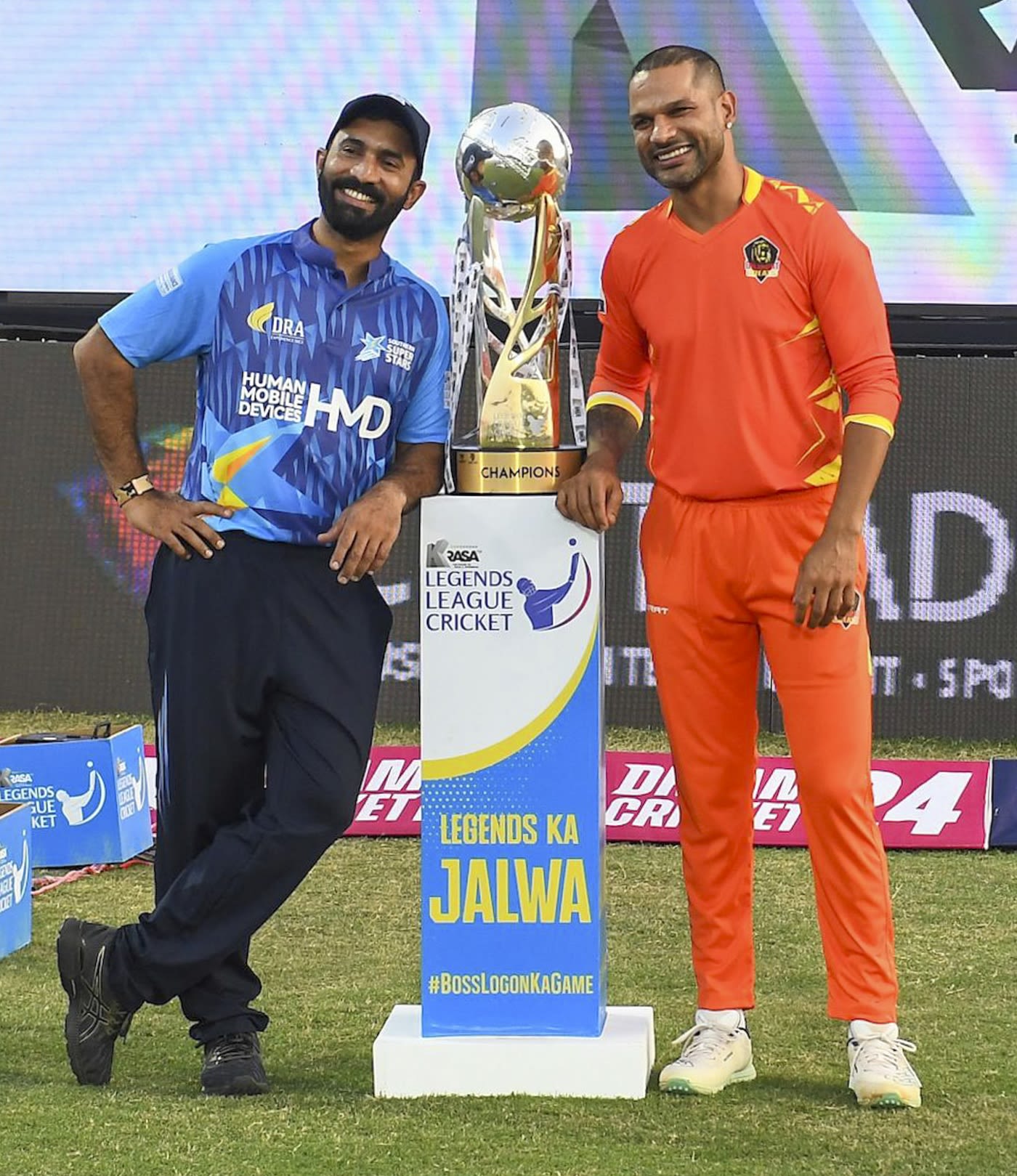 Dinesh Karthik and Shikhar Dhawan pose with the Legends League Trophy