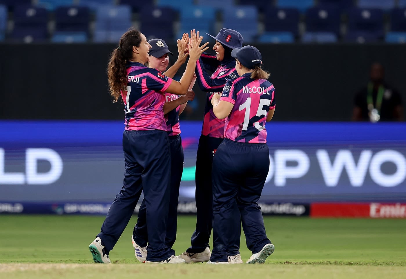 Priyanaz Chatterji celebrates with her team-mates after taking a wicket