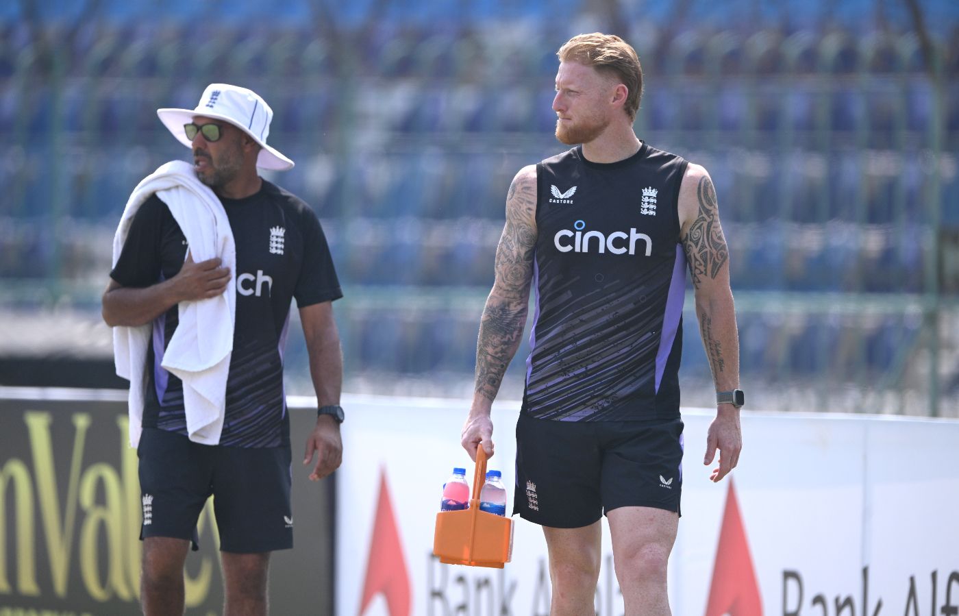 Ben Stokes runs the drinks on a hot day in Multan