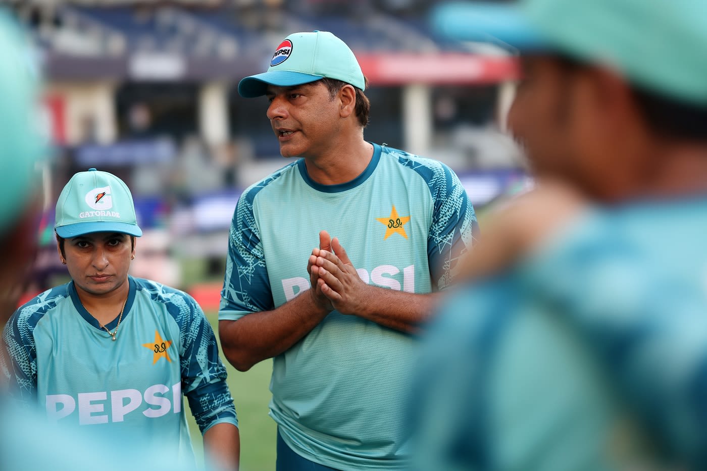 Nida Dar listens intently as head coach Mohammad Wasim gives a pep talk