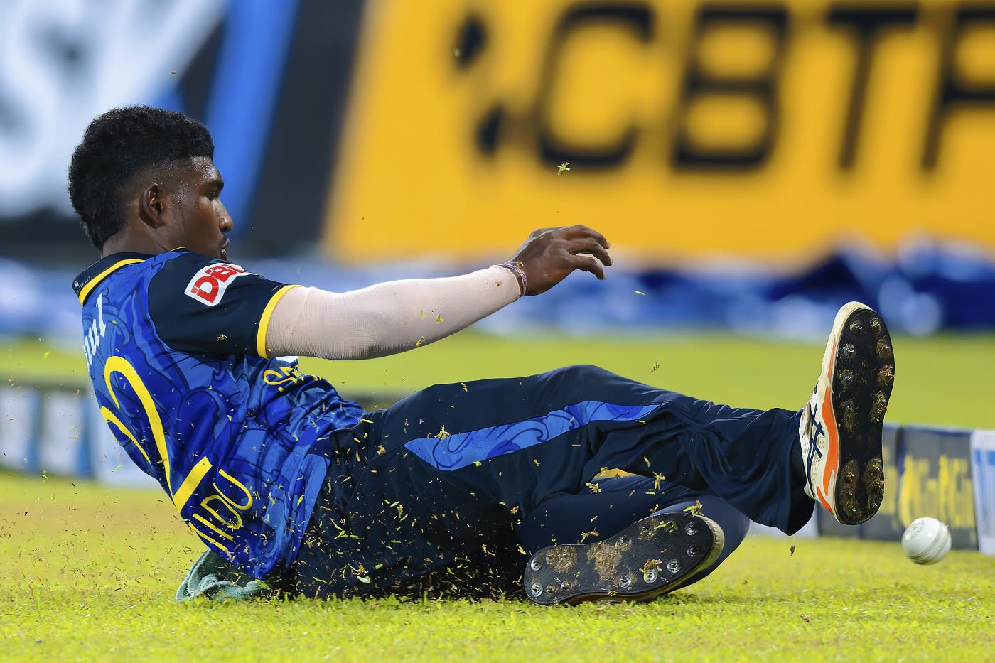 Chamindu Wickramasinghe slides across the field