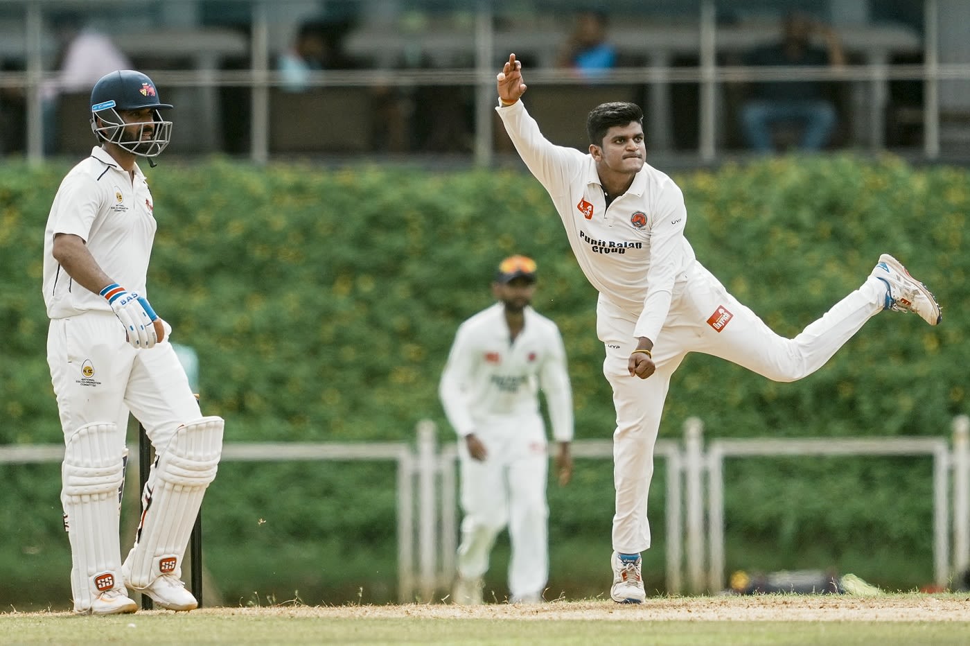 Satyajeet Bachhav bowls as Ajinkya Rahane looks on from the non-striker's end