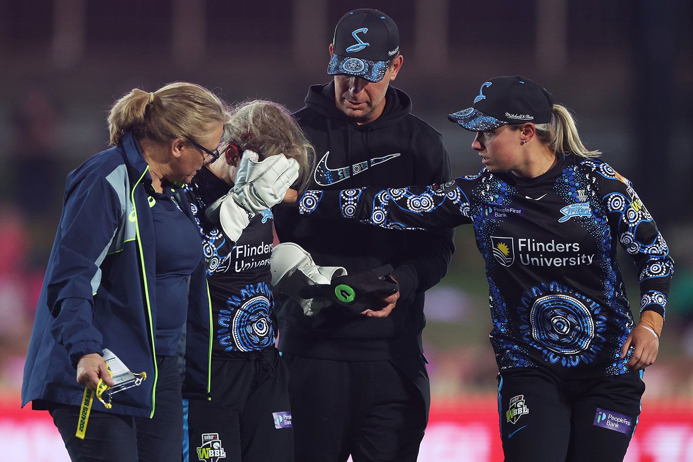 Bridget Patterson leaves the field after taking a blow in the face