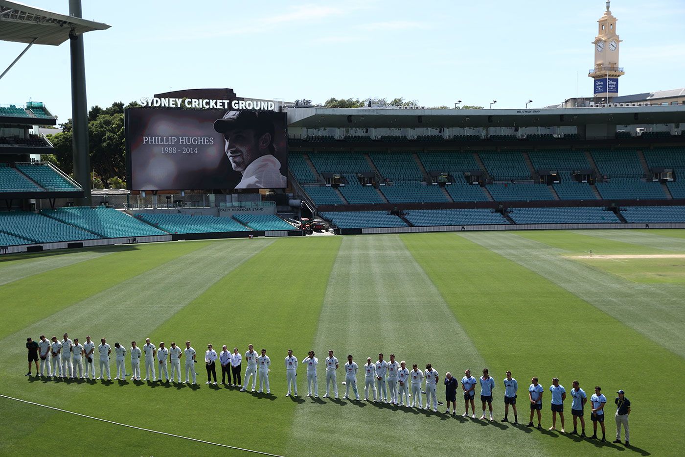 The teams line up at the SCG to remember Phillip Hughes