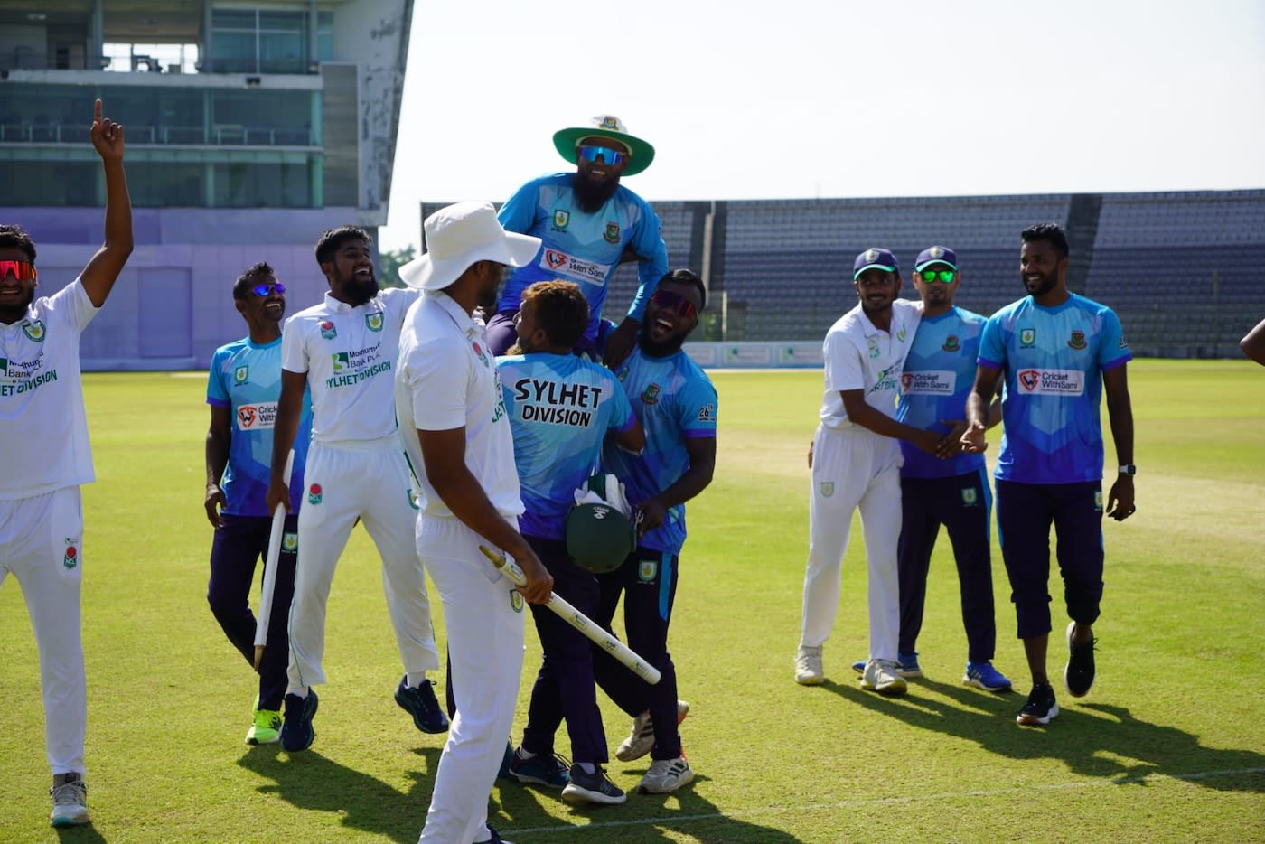 Sylhet Division head coach Rajin Saleh is lifted by support staff members after victory