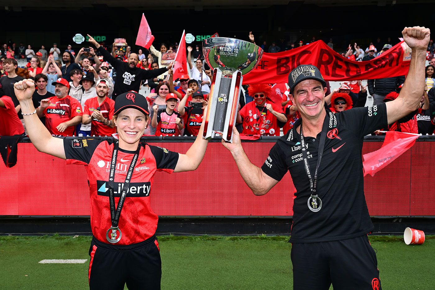Sophie Molineux and Simon Helmot in front of Melbourne Renegades fans