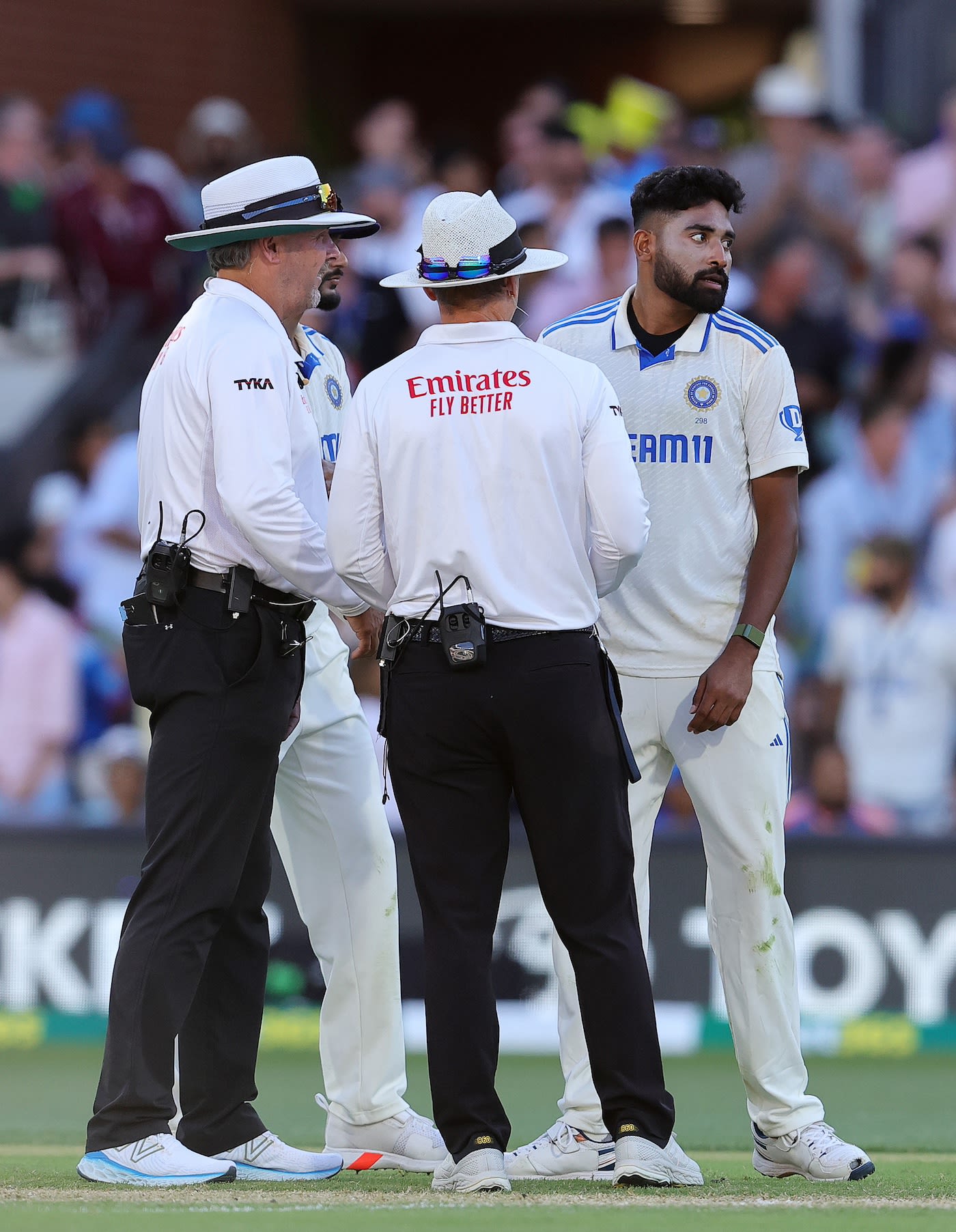 Umpires Chris Gaffaney and Richard Illingworth have a chat with Mohammed Siraj