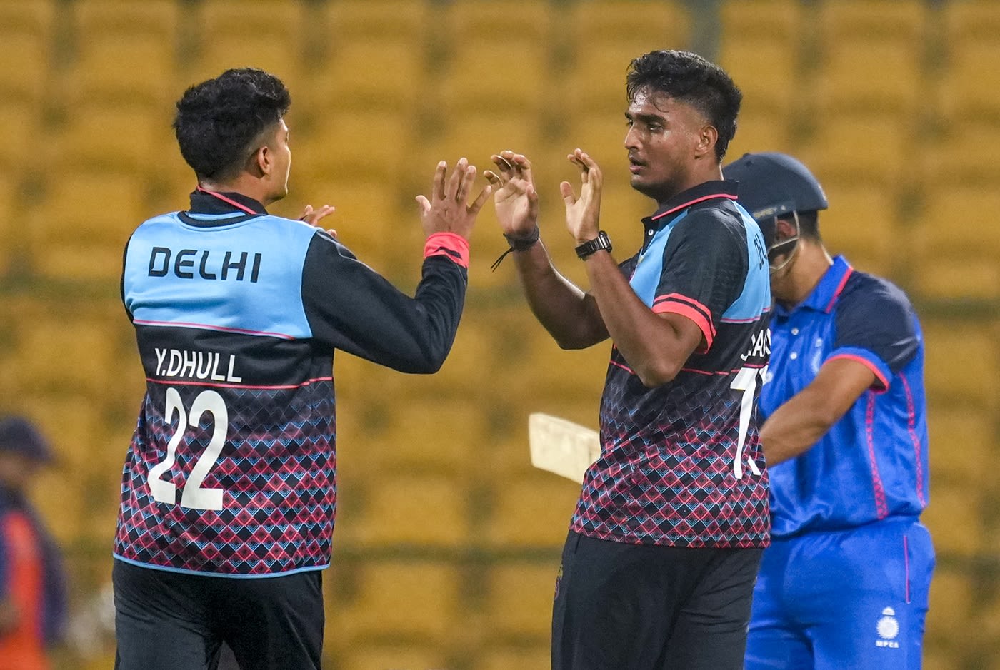 Himanshu Chauhan celebrates a wicket with Yash Dhull