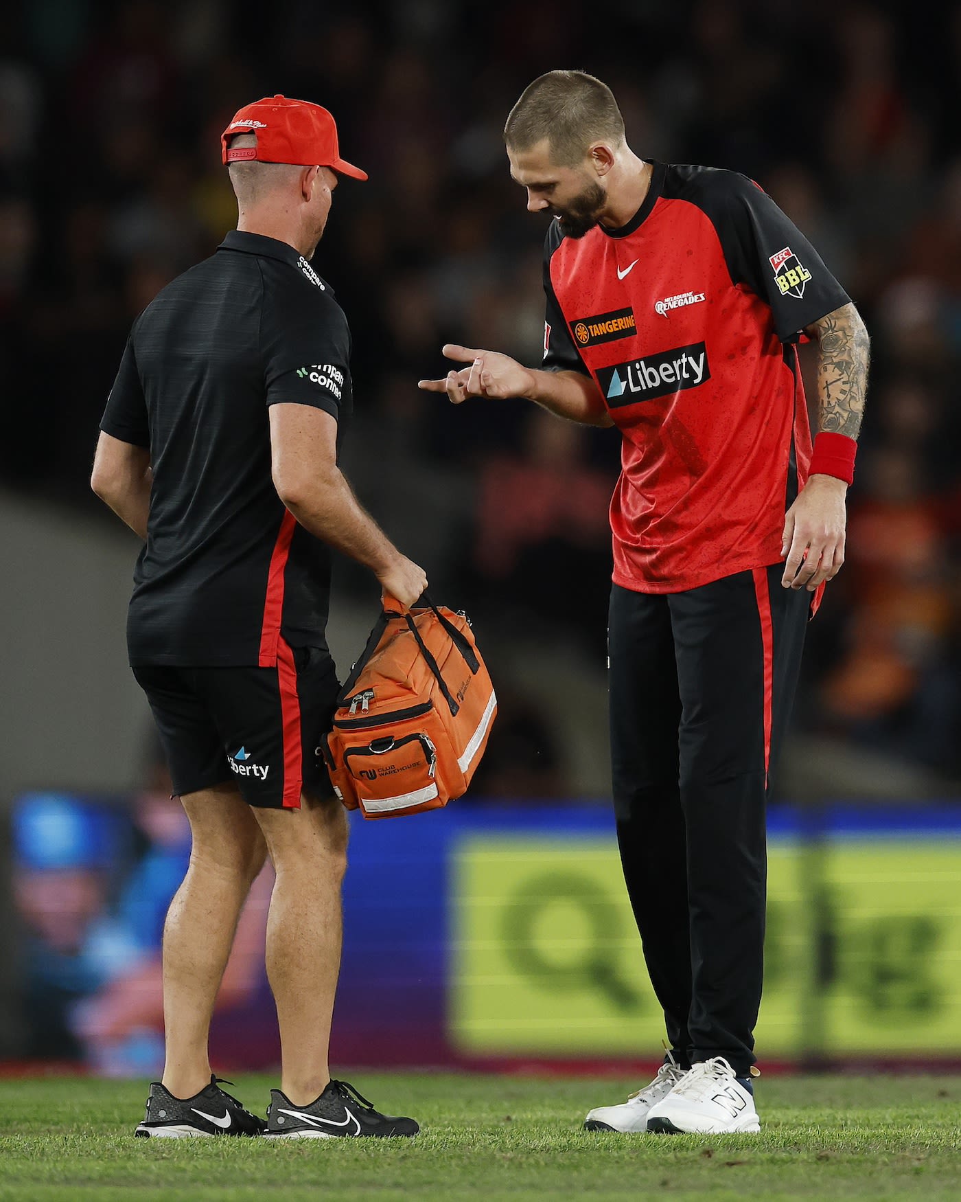 Kane Richardson receives treatment after getting a cut on his finger