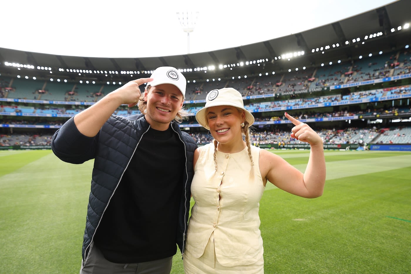 Jackson Warne and Brooke Warne pose with hats for their father Shane Warne