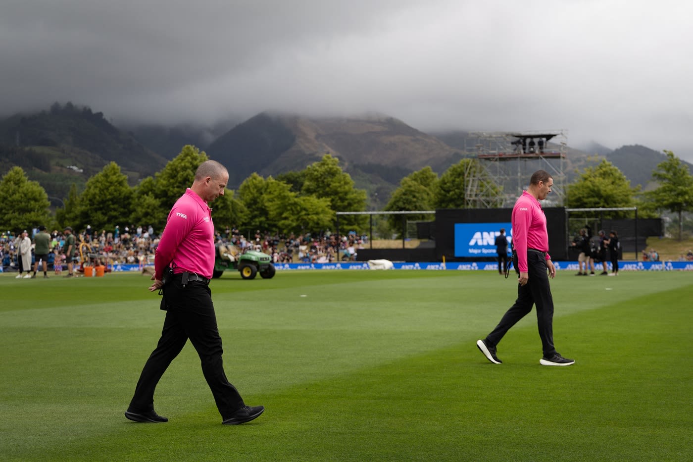 Umpires Chris Brown and Shaun Haig inspect the outfield after morning rain delayed the toss