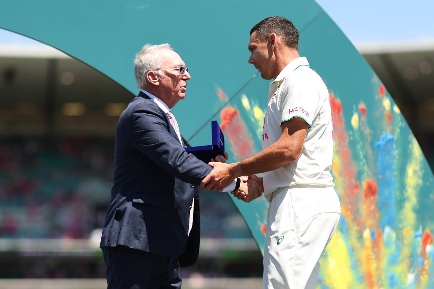 Scott Boland receives his Player-of-the-Match award from Allan Border