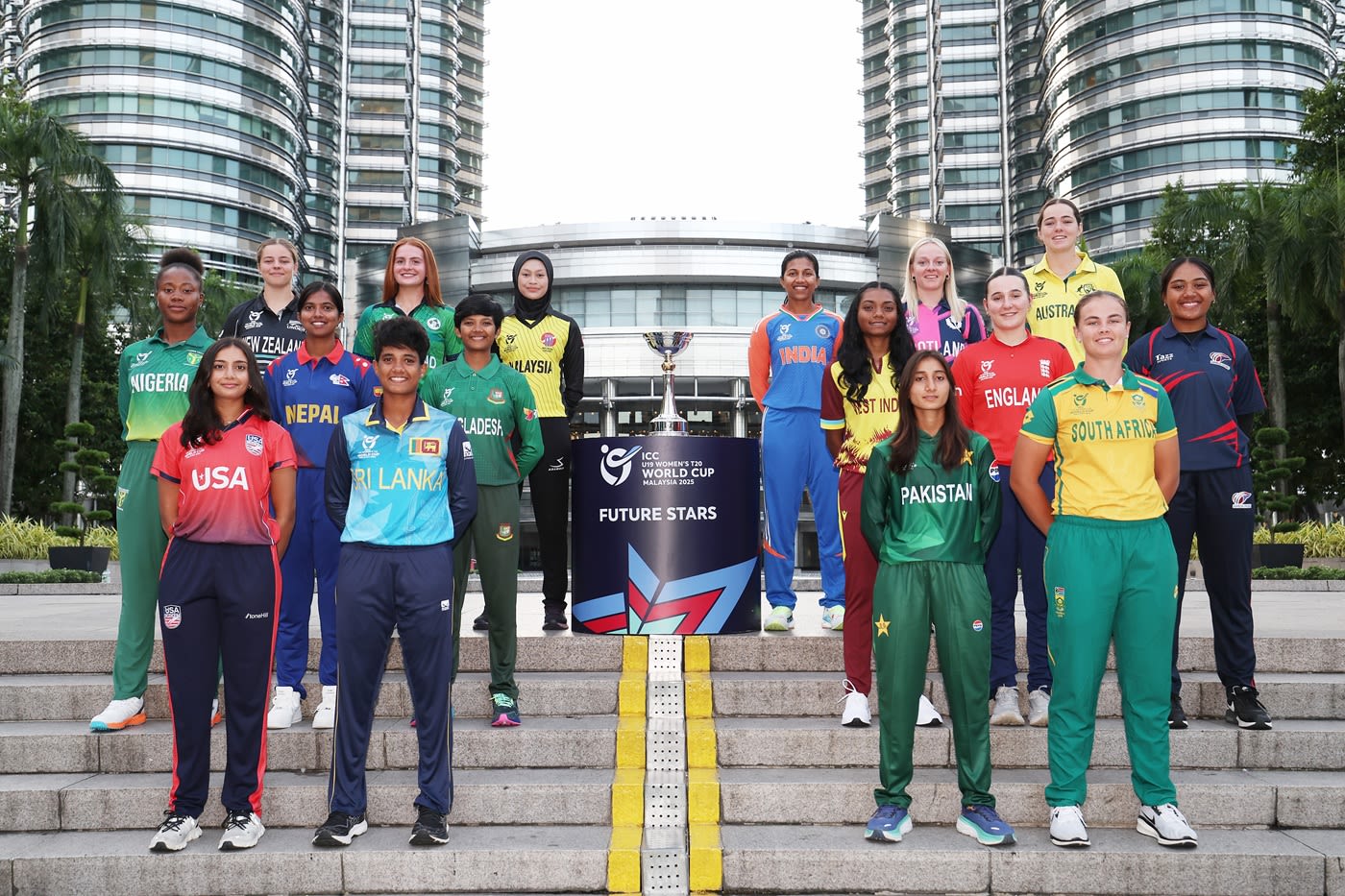 The 16 captains of the upcoming Women's U-19 World Cup get photographed in front of the Petronas Towers in Kuala Lumpur