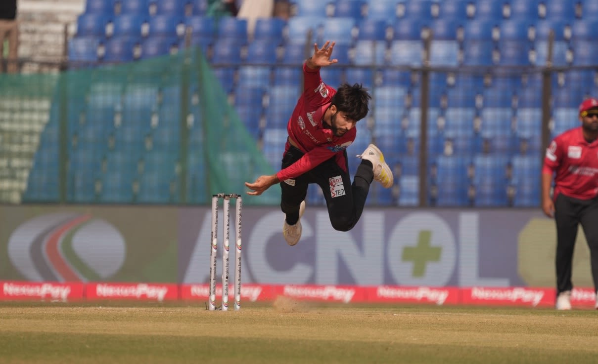 Jahandad Khan is airborne after delivering the ball