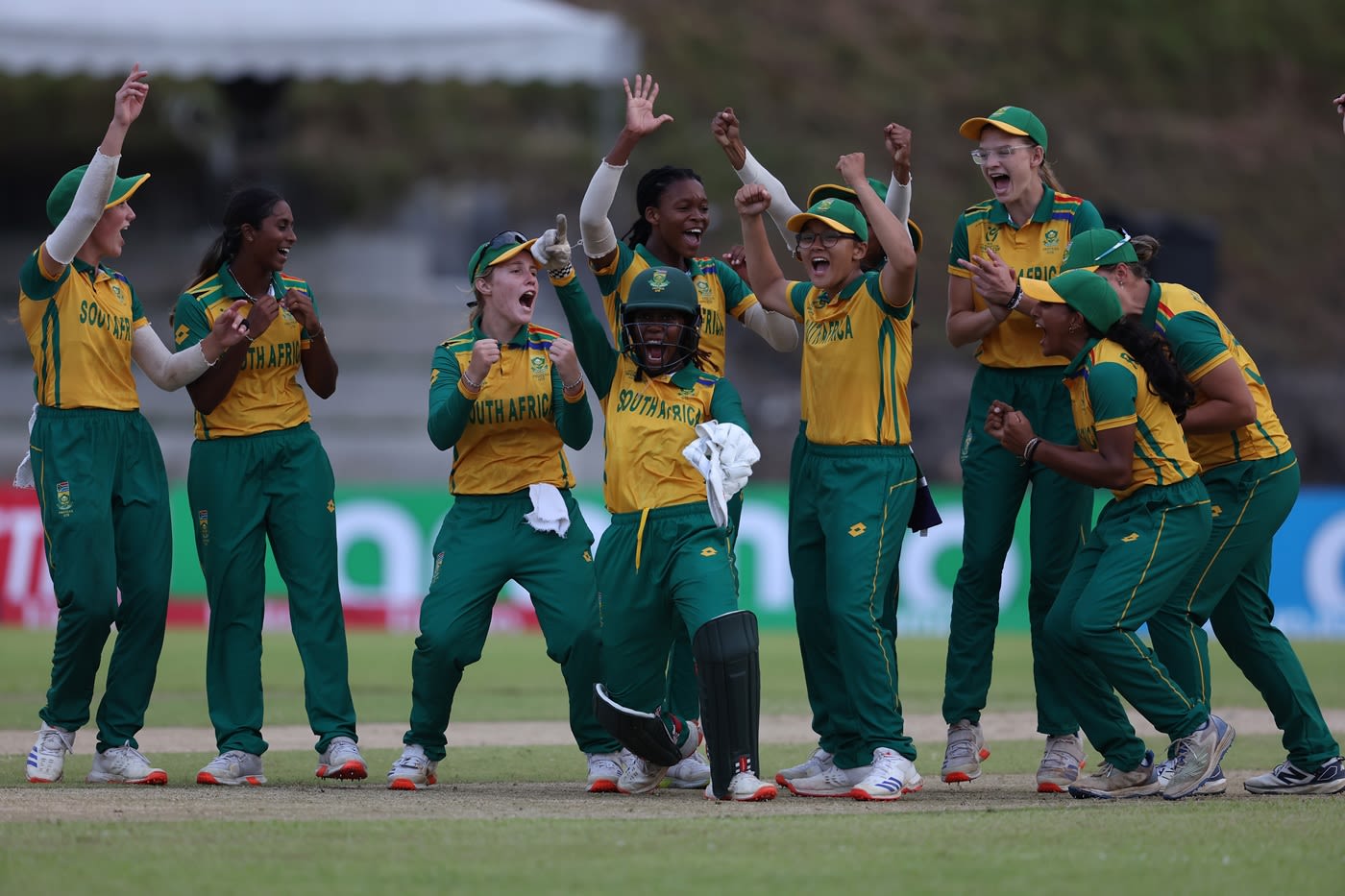 South Africa, led by Seshnie Naidu and wicketkeeper Karabo Meso, celebrate a Nigerian wicket