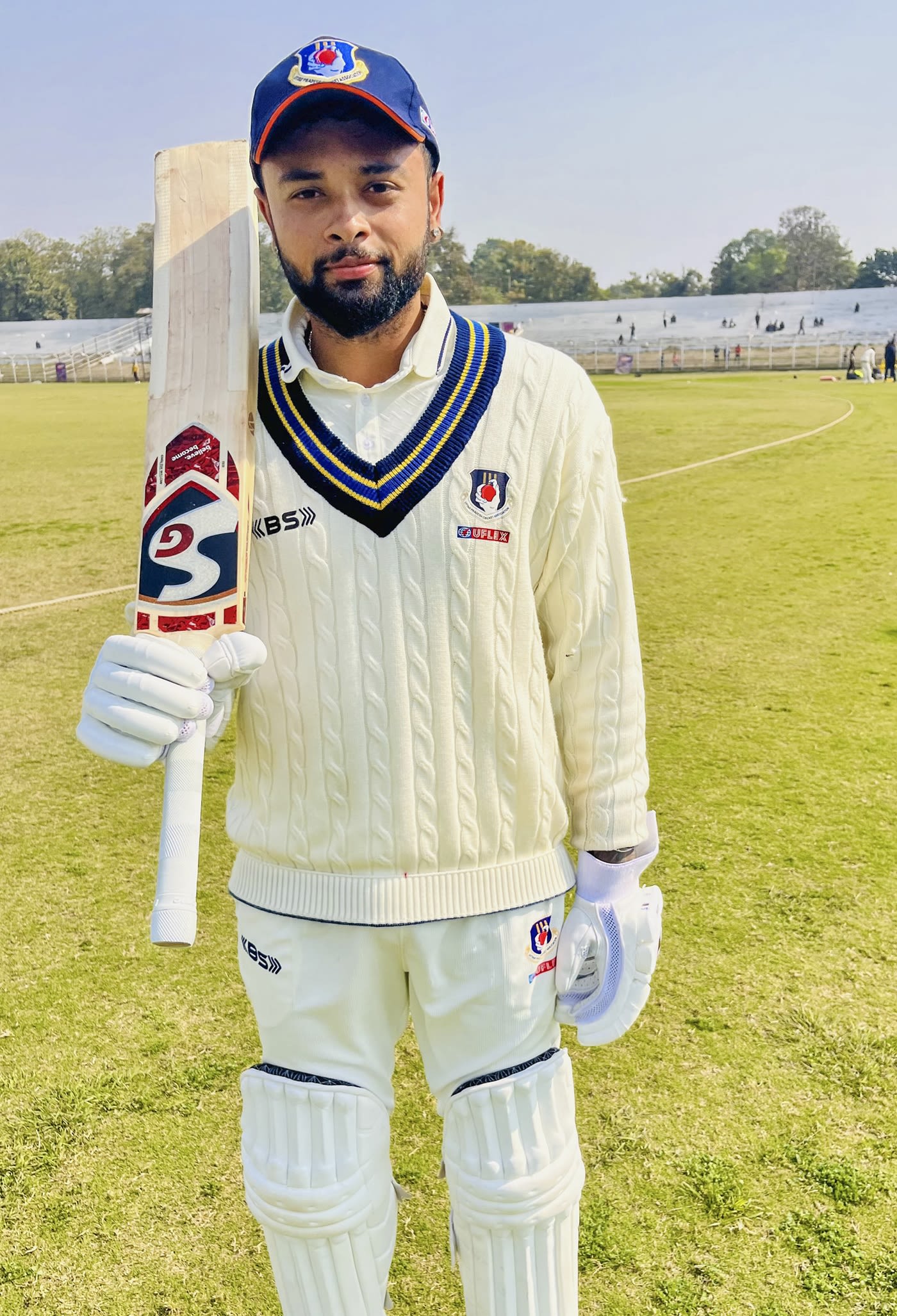 Karan Sharma poses after scoring 118 not out