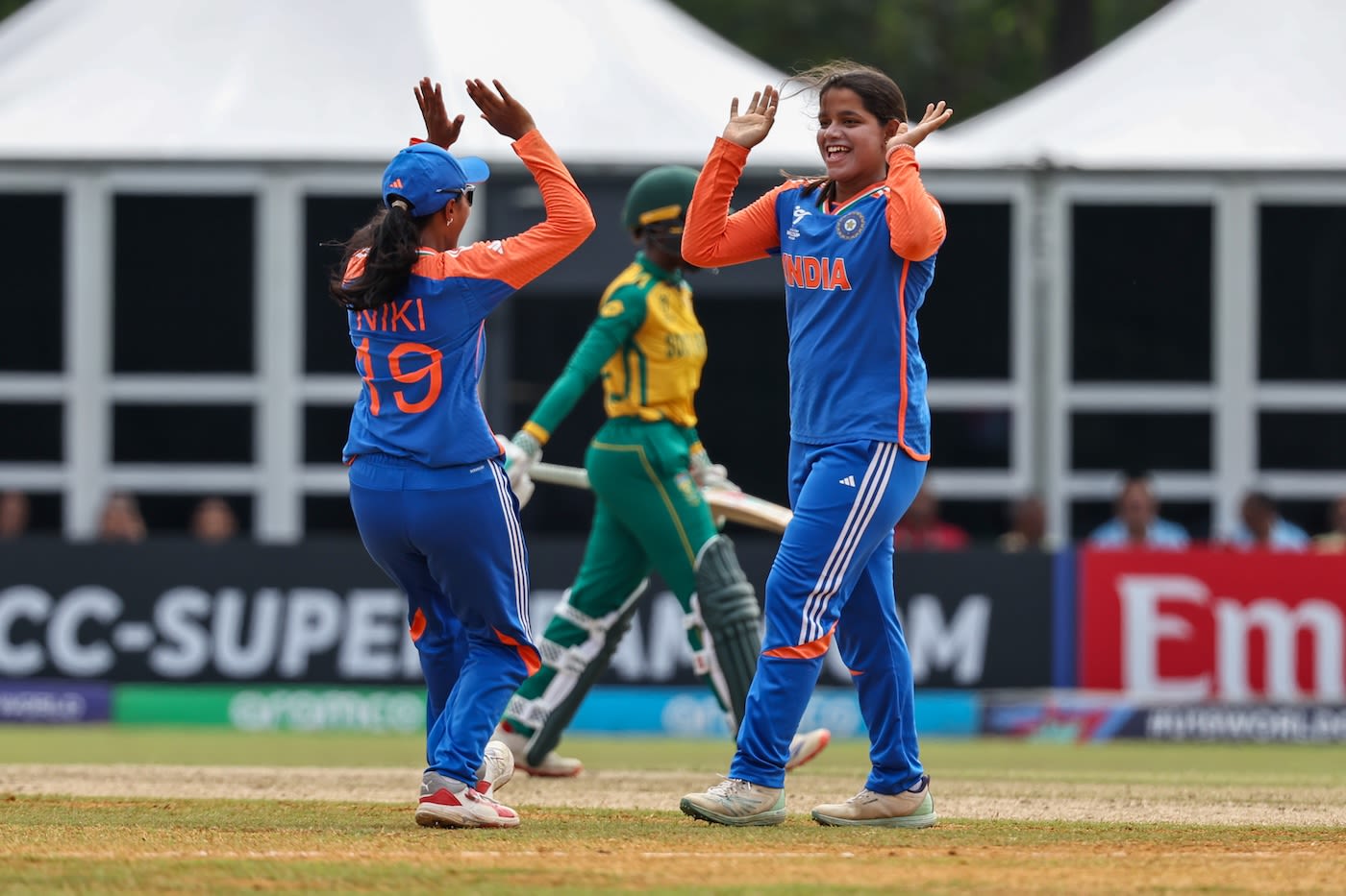 Captain Niki Prasad goes on to congratulate Aayushi Shukla after a wicket