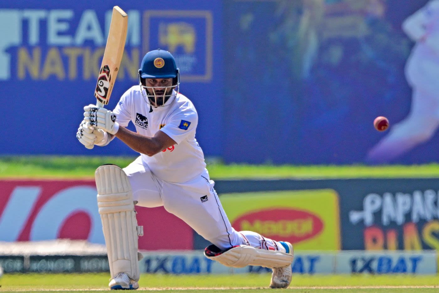Dimuth Karunaratne drives through the offside