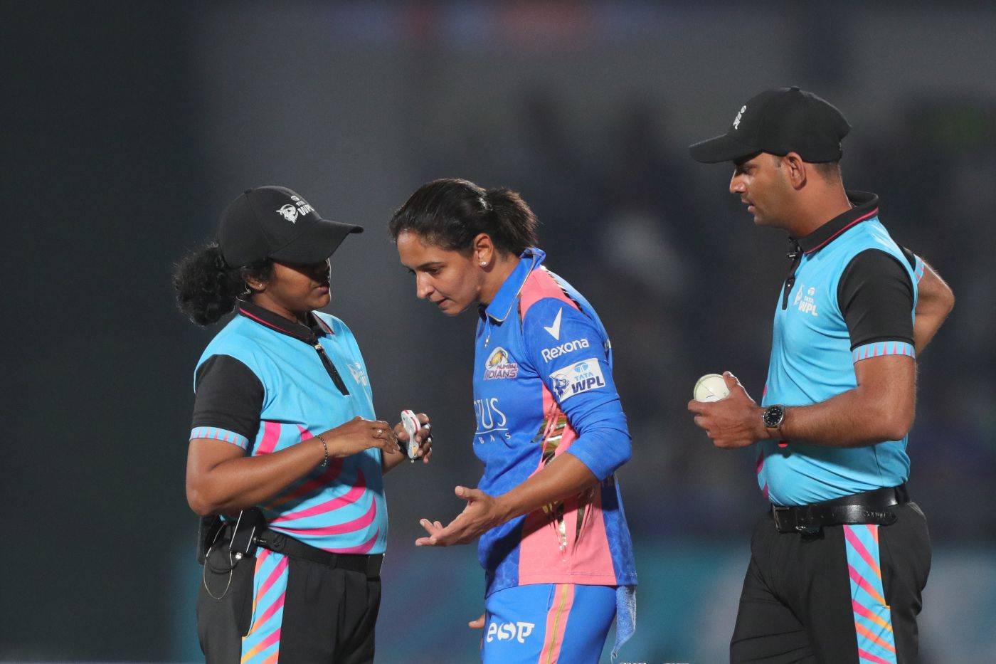 Mumbai Indians captain Harmanpreet Kaur in conversation with umpire N Janani about the Shikha Pandey not-out run-out incident. Umpire Anish Sahasrabudhe listens in