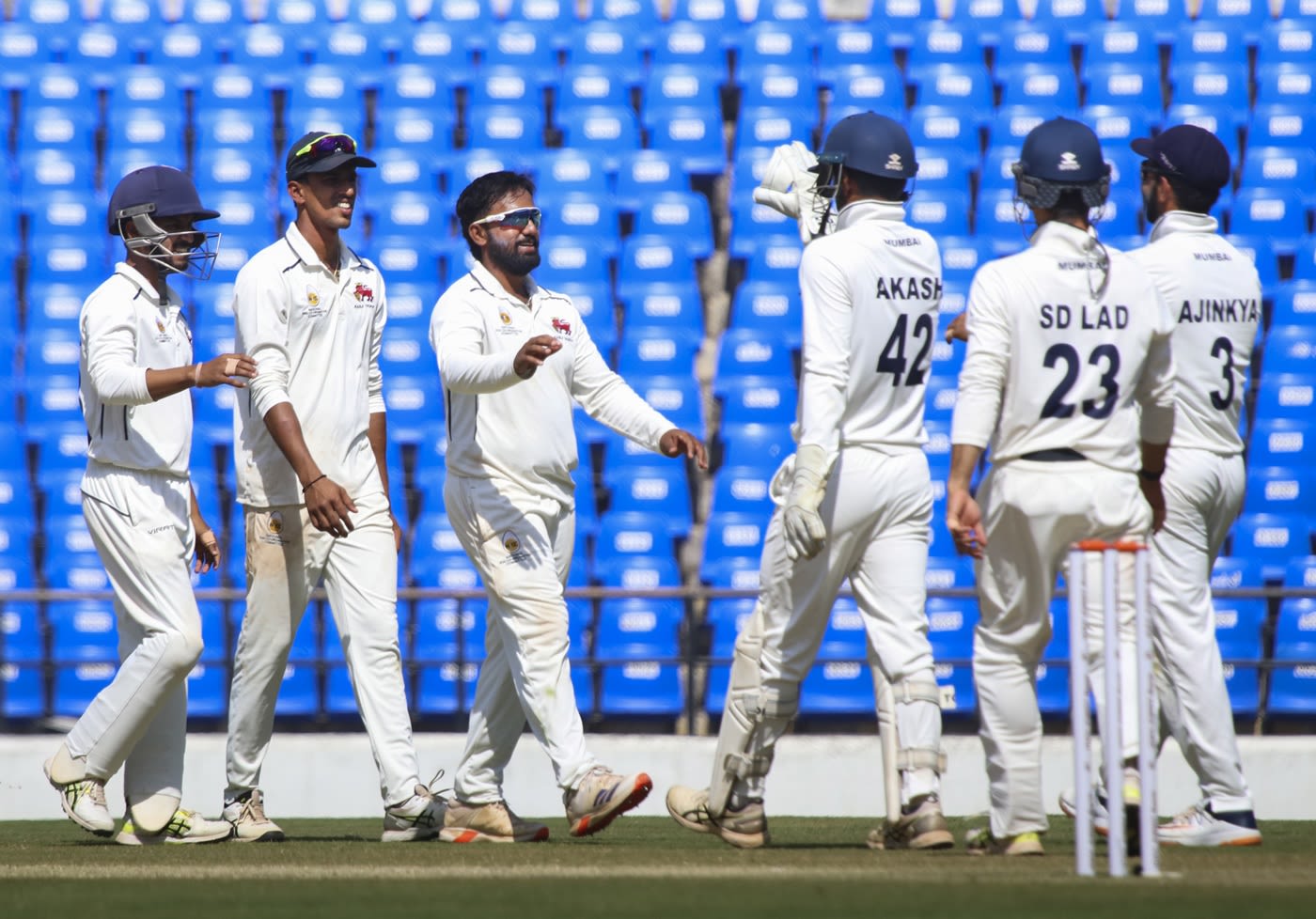 Shams Mulani celebrates a wicket with his team-mates