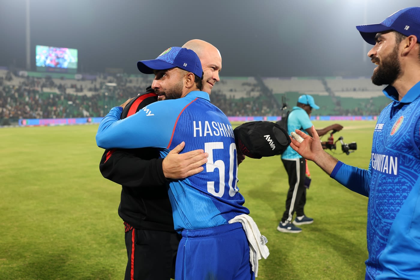 Jonathan Trott and Hashmatullah Shahidi embrace after Afghanistan's win