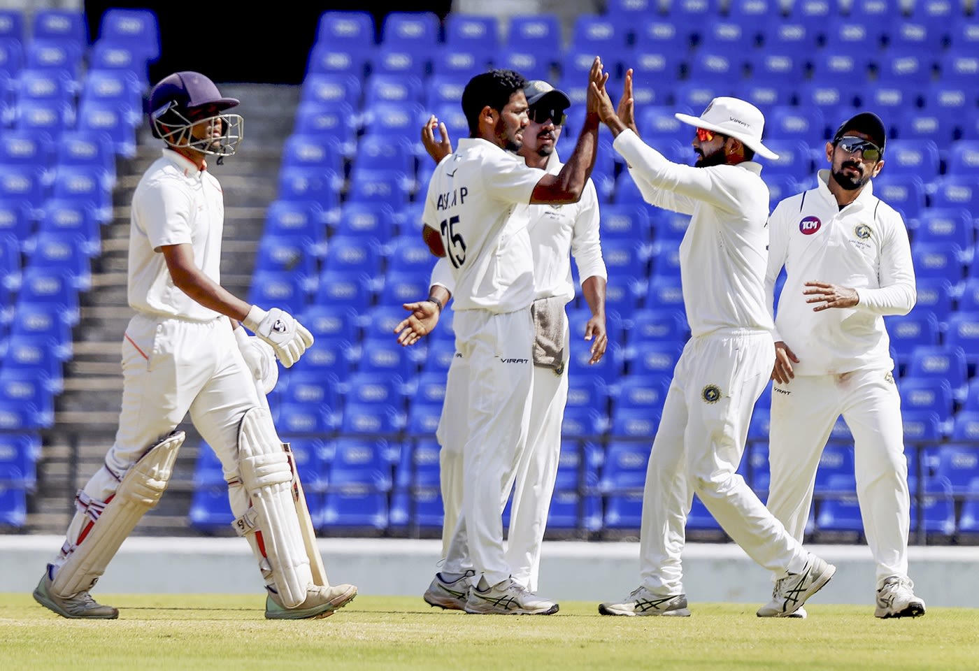 Nedumankuzhy Basil celebrates with his team-mates after dismissing Danish Malewar