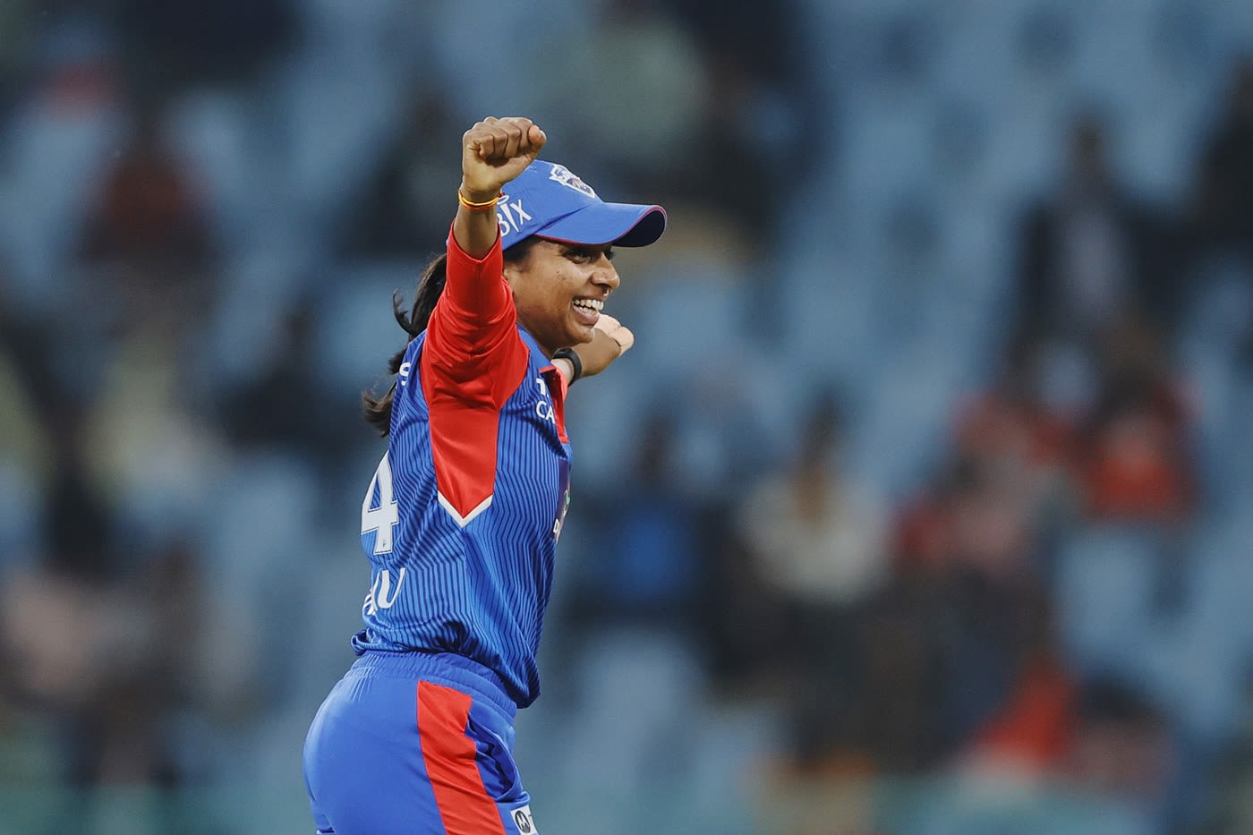 Minnu Mani wheels away after taking a wicket