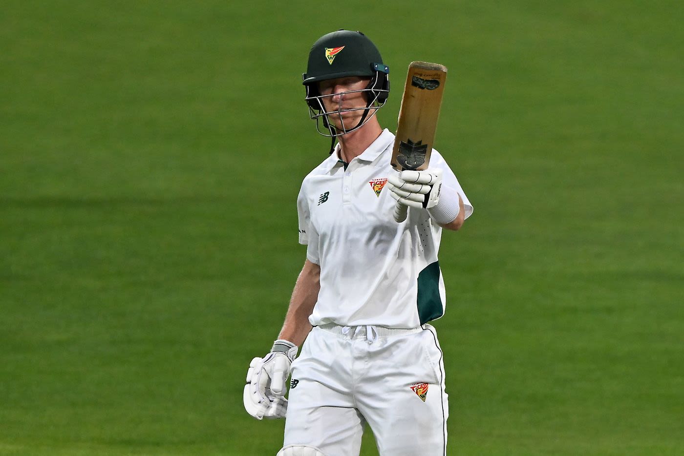 Jordan Silk raises his bat in his 100th Sheffield Shield match