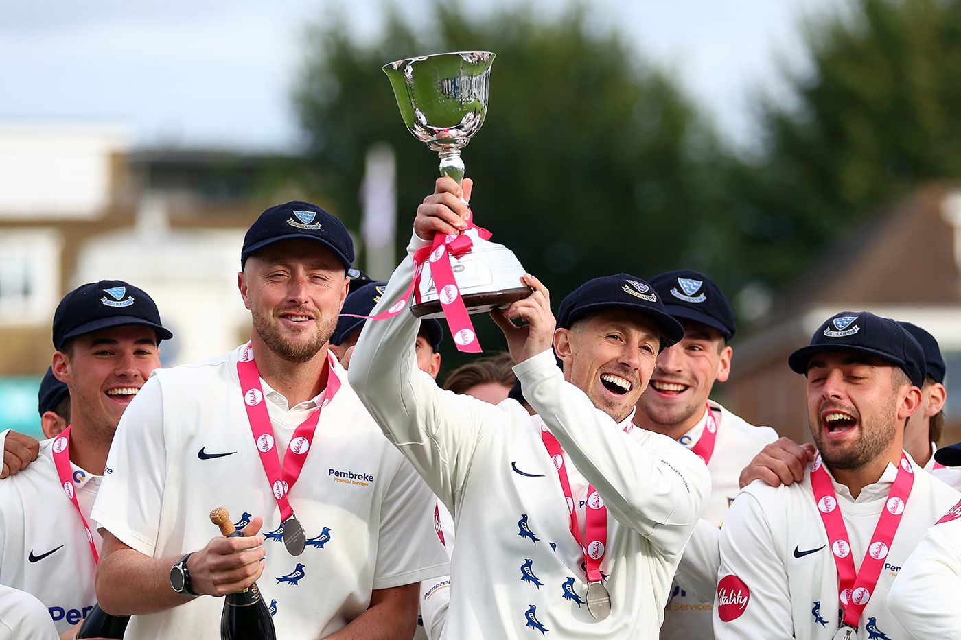 John Simpson holds the Division Two trophy aloft