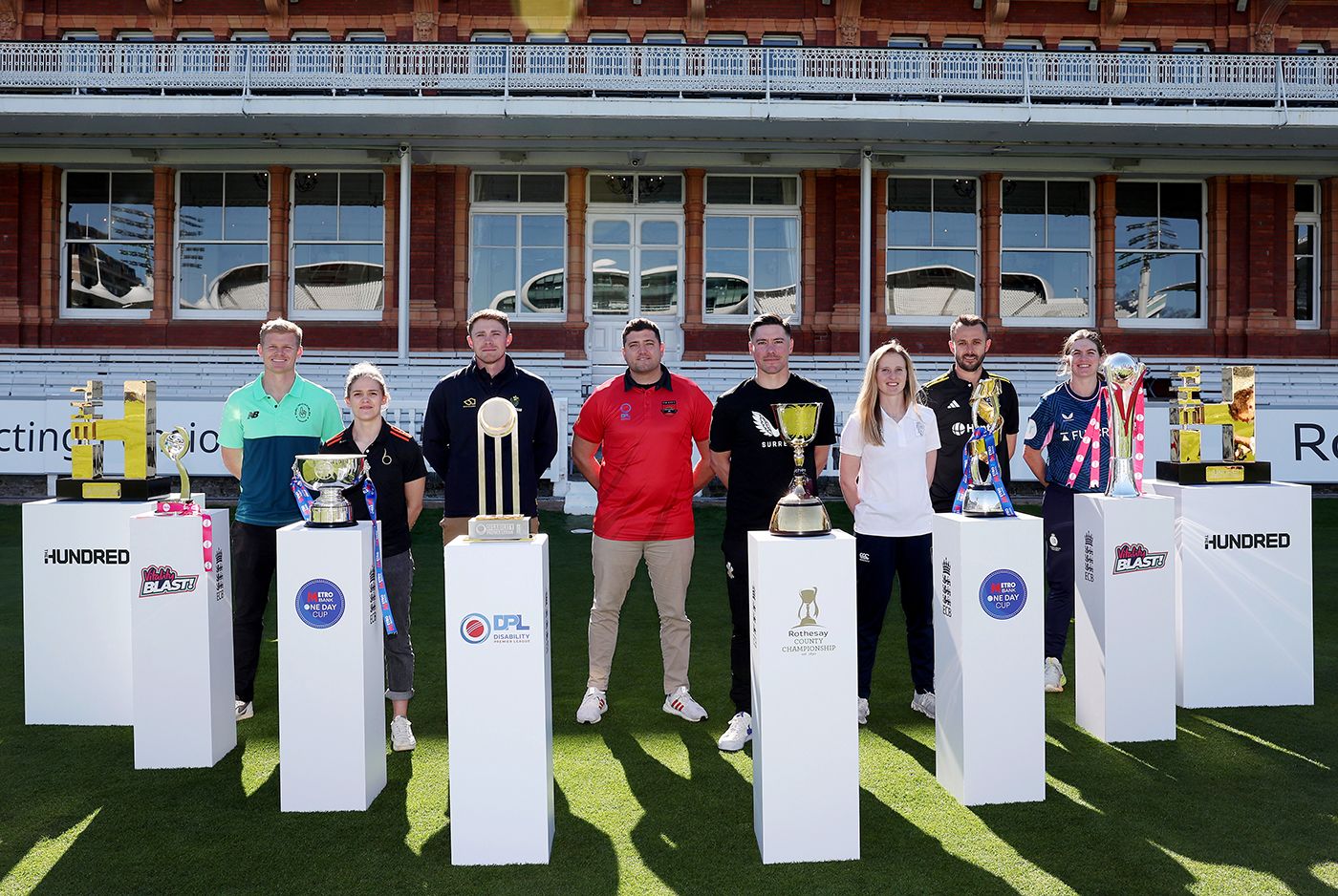 Sam Billings, Lucy Higham, Dan Douthwaite, Anthony Clapham, Rory Burns, Emily Windsor, Jack Taylor and Saskia Horley pose with the domestic trophies at the ECB's season launch