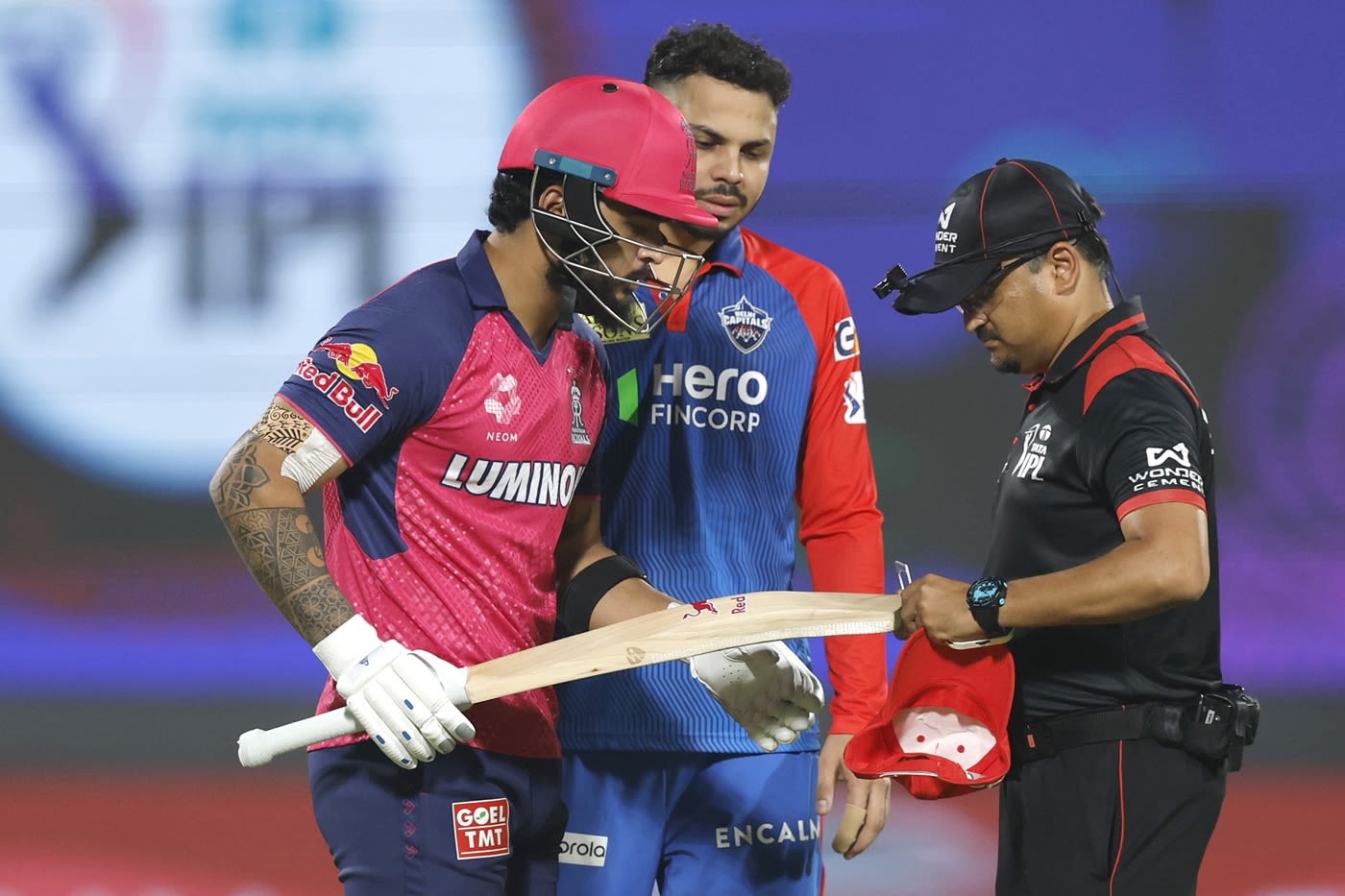 Umpire Akshay Totre checks Riyan Parag's bat