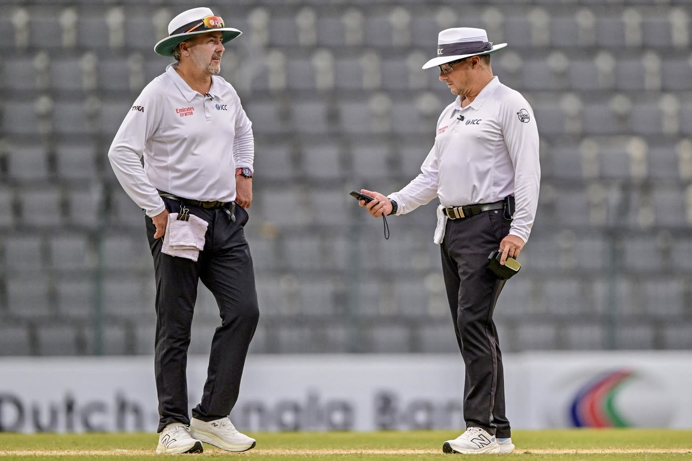 Umpires Richard Illingworth and Richard Kettleborough take out the light meter