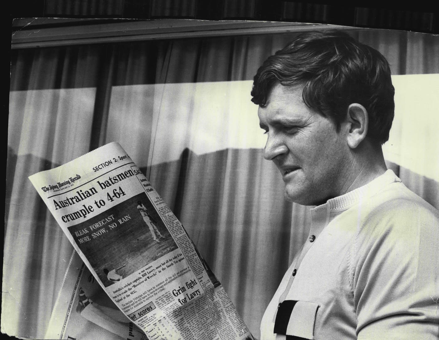 Keith Stackpole reads a newspaper