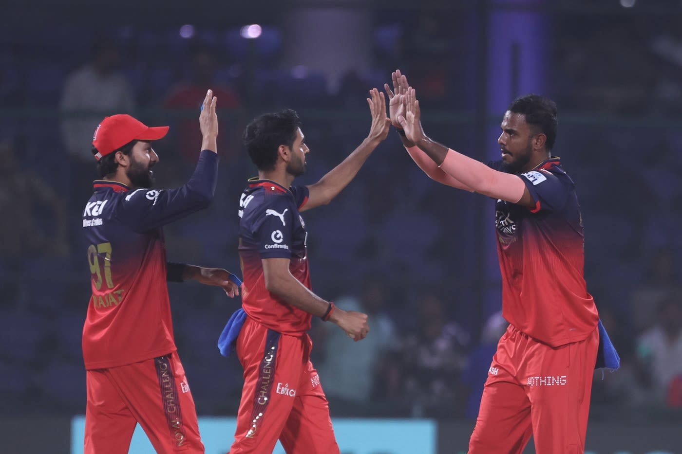 Rajat Patidar and Bhuvneshwar Kumar high-five Yash Dayal after a wicket
